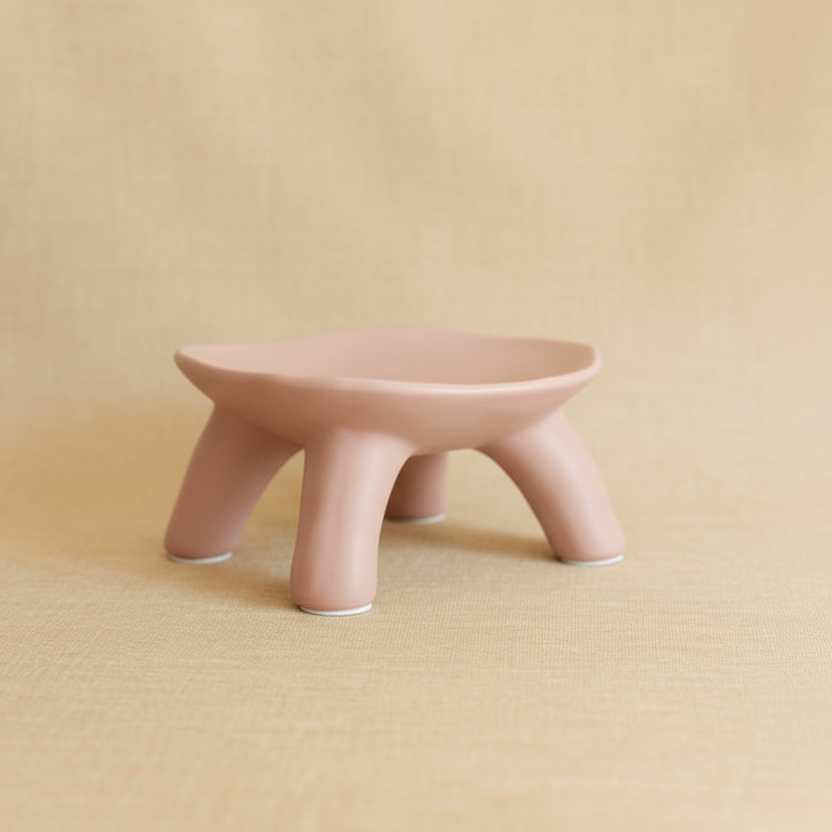Pink ceramic stool on a beige background