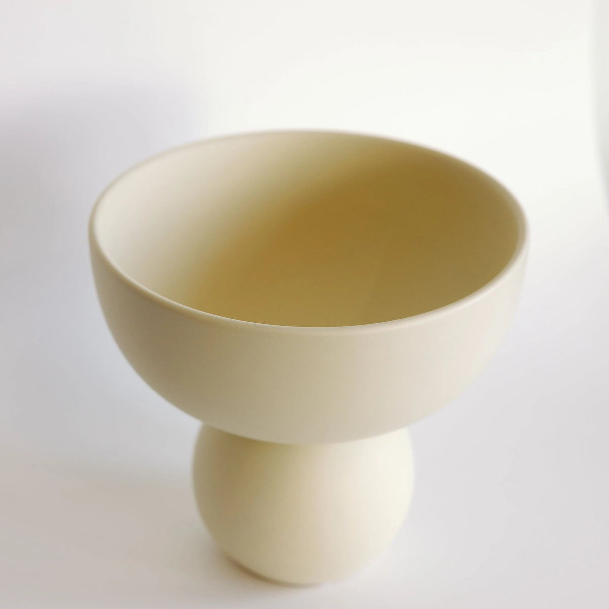Sophie cream ceramic vase shot from above, showing the open bowl interior and spherical pedestal foot