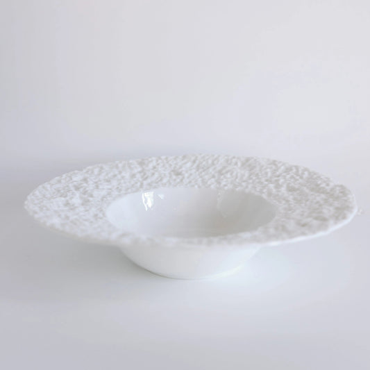 White Fallen Snow bowl at an angle, showing low footed base and crusty textured wide rim