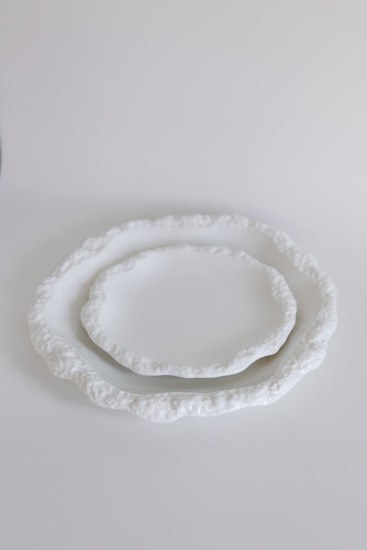 Two white Amalfi porcelain plates stacked to show size, both with textured organic rims on white.
