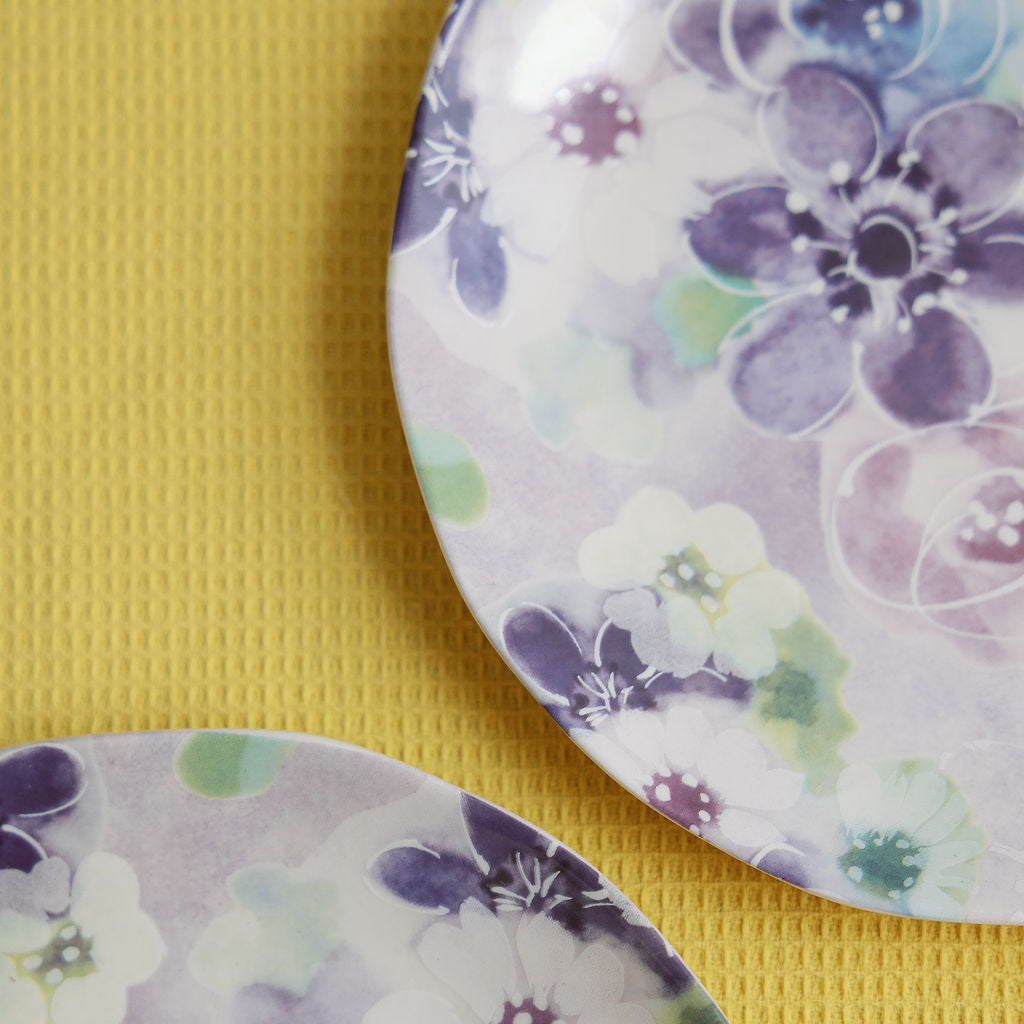 Two floral-patterned plates on a yellow background