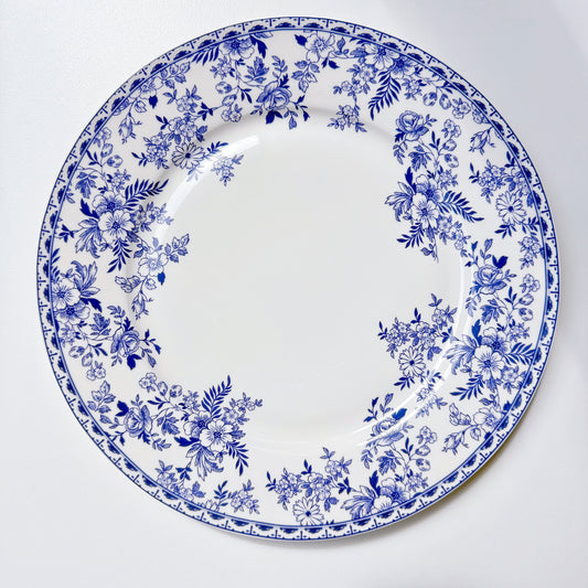 Indigo Wildflower blue floral porcelain dinner plates layered on a table