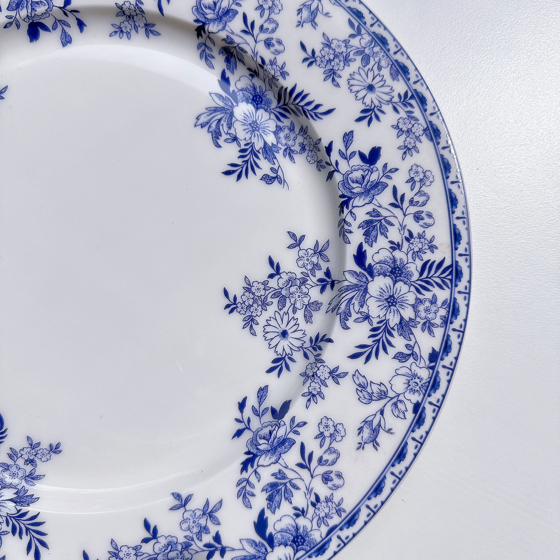 White plate with blue floral pattern on a white background