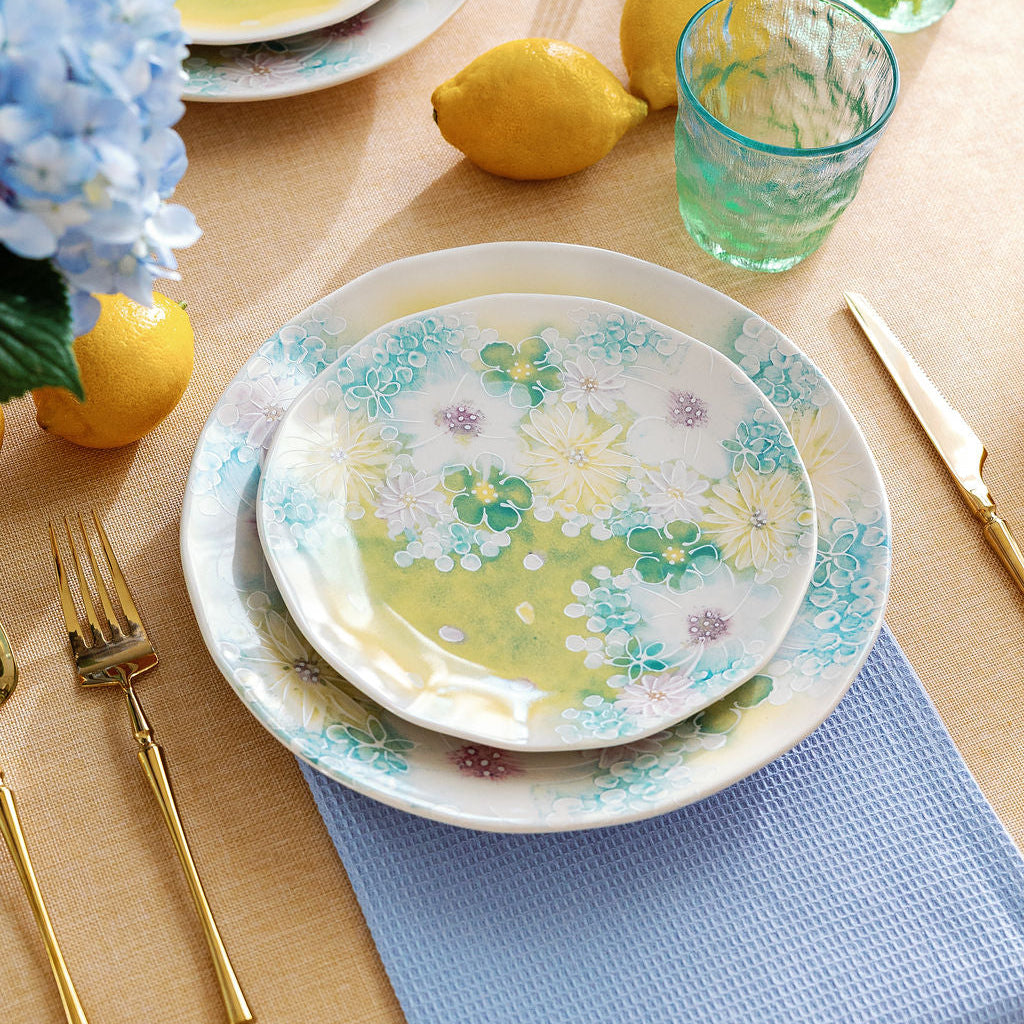 Watercolor meadow porcelain dinner plate set with pastel blue and lavender floral pattern, styled with blue napkins