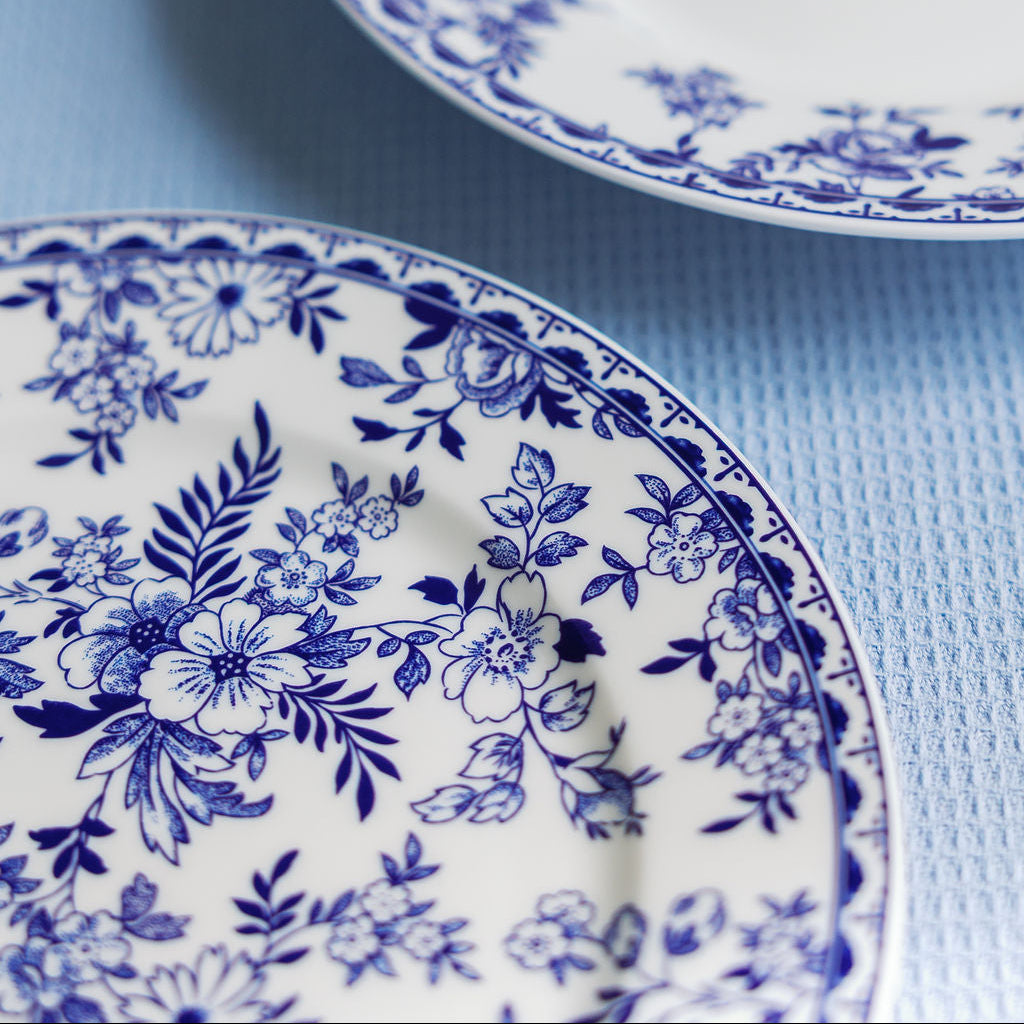 Two blue floral-patterned plates on a light blue background