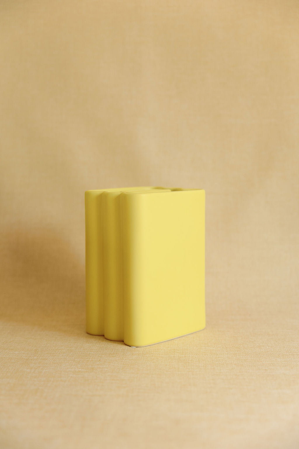 Yellow rectangular block on a beige background