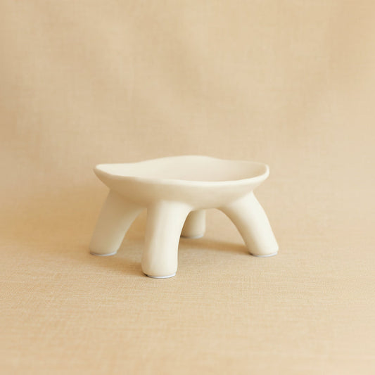 Light cream ceramic dish on a beige background