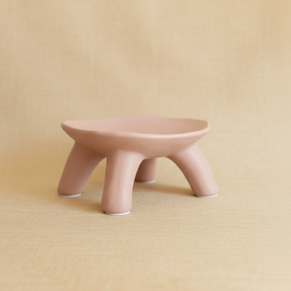 Pink ceramic stool on a beige background