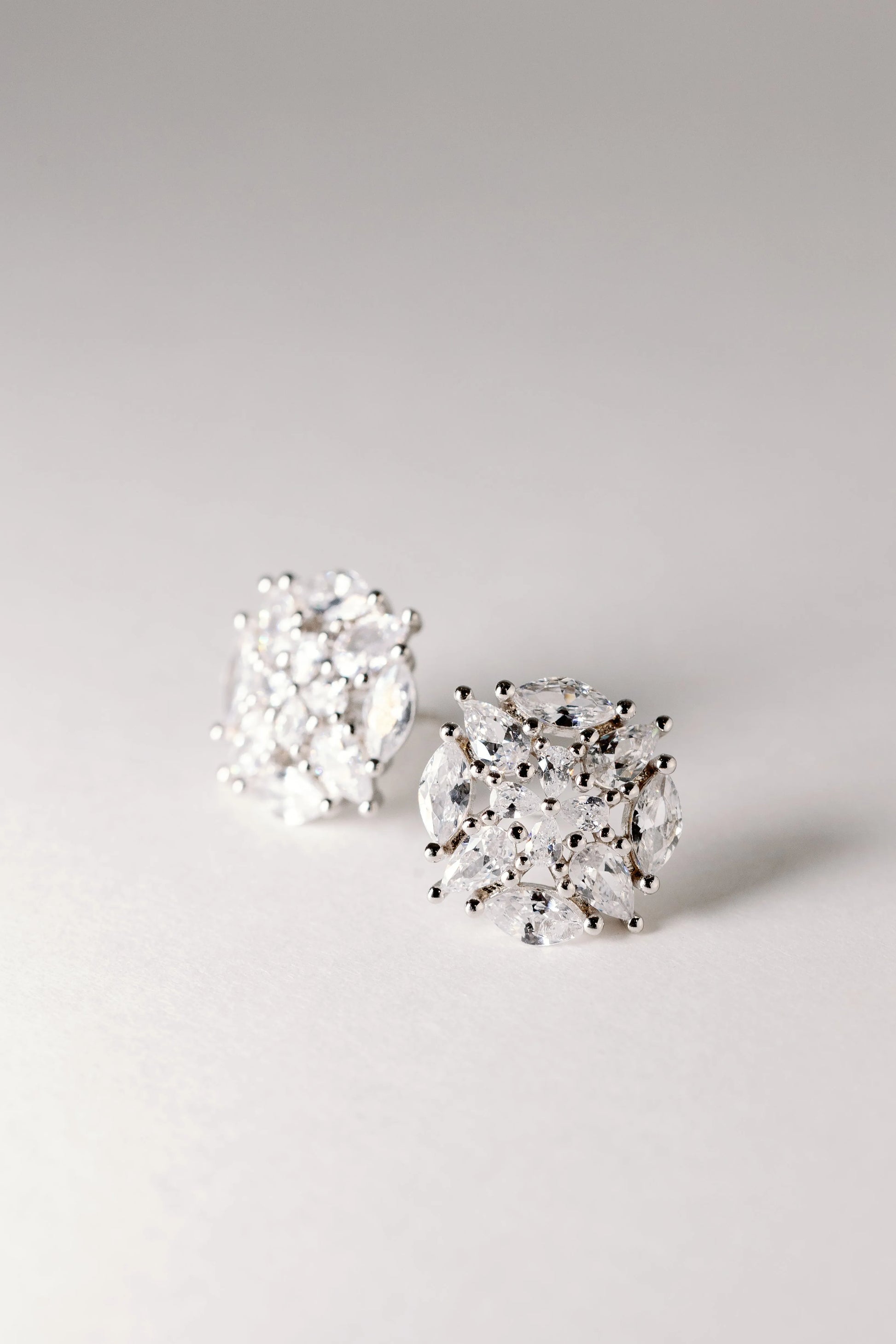 Crystal Starburst studs pair, silver clusters of marquise and round crystals in a domed setting on grey
