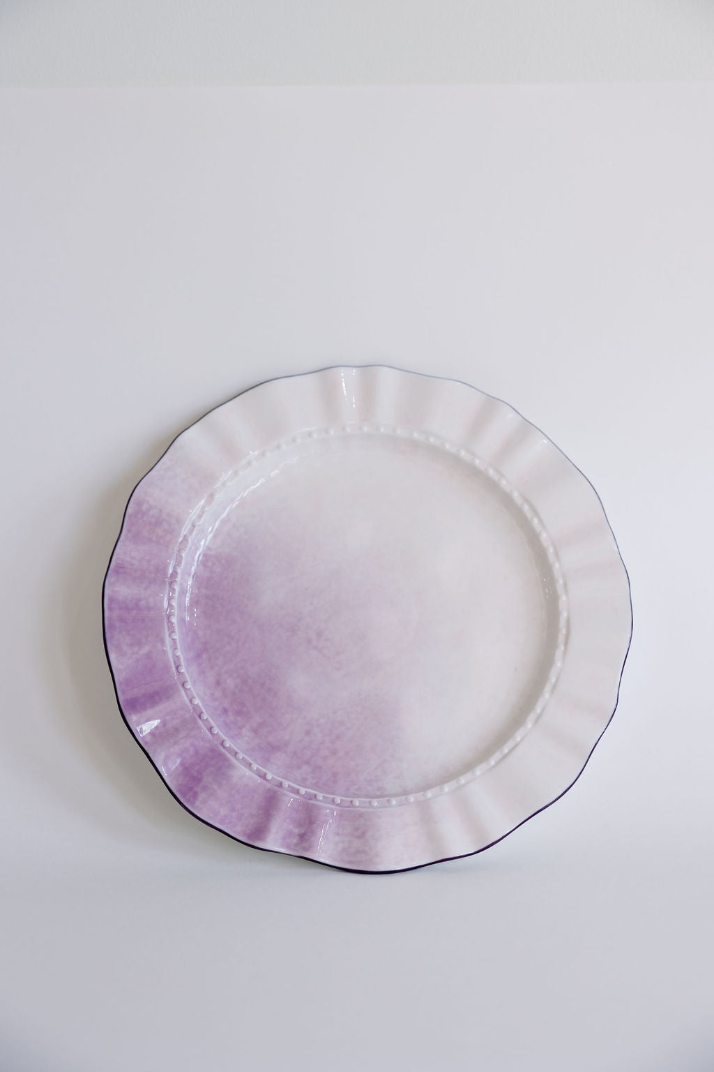 Lavender ombre ruffle pasta plate with beaded rim, layered on a larger scalloped plate.