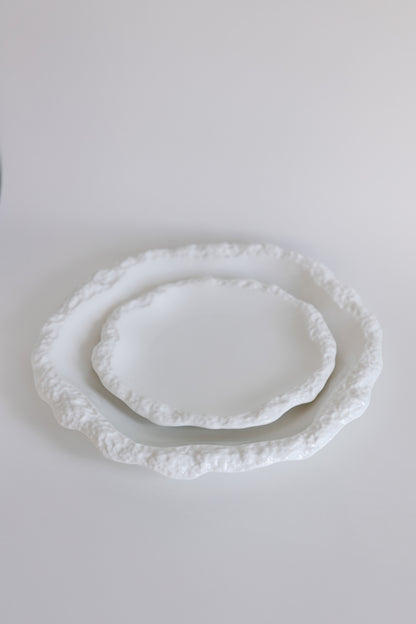 Two white Amalfi porcelain plates stacked to show size, both with textured organic rims on white.