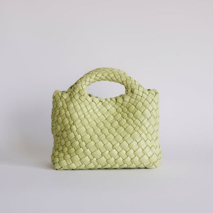 Light green woven handbag on a light gray background
