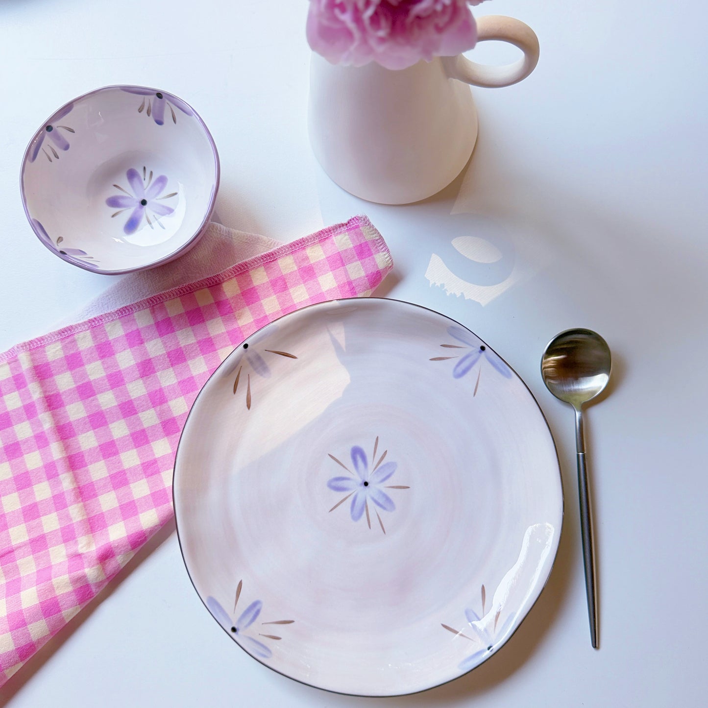 Lilac sculpted orchid porcelain dinner plate with purple flower motif, styled with matching bowl, gingham and a peony vase.