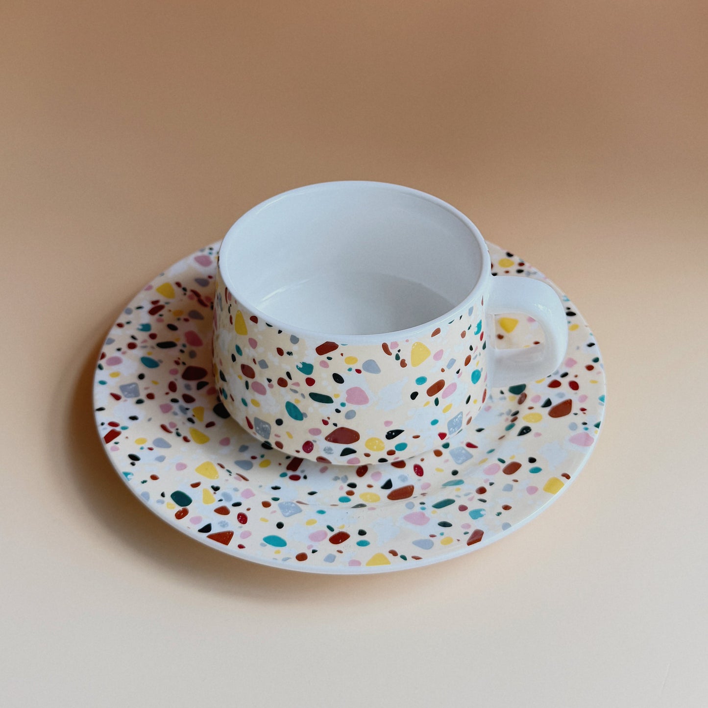 Terrazzo porcelain tea cup and saucer with multicolor terrazzo speckled pattern