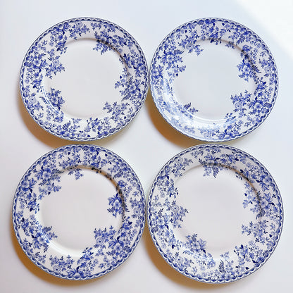 Four blue and white floral-patterned plates on a white background