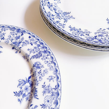Blue floral patterned plates on a white surface