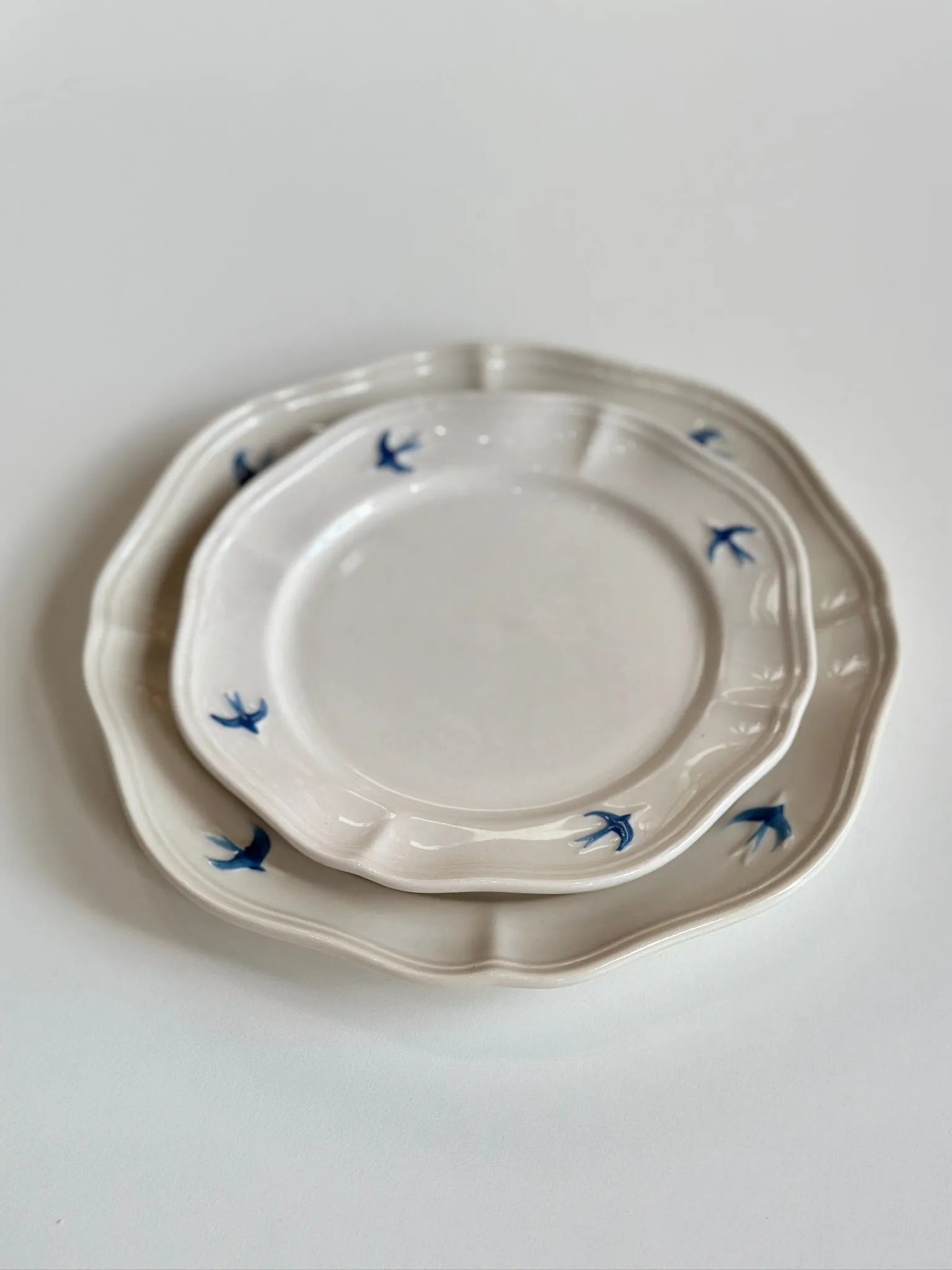 Painted bluebird porcelain dinner plate styled on linen tablecloth, full cottagecore place setting