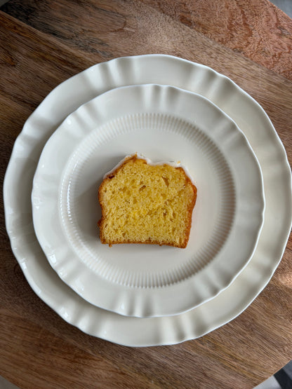 Slice of cake on a white plate with a wooden background