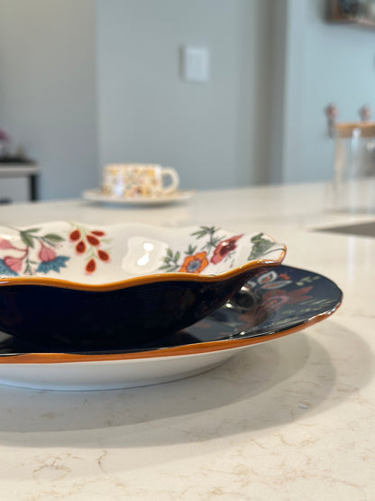 Azure Desert Floral scalloped salad bowl with navy and orange rim, styled on a kitchen counter.