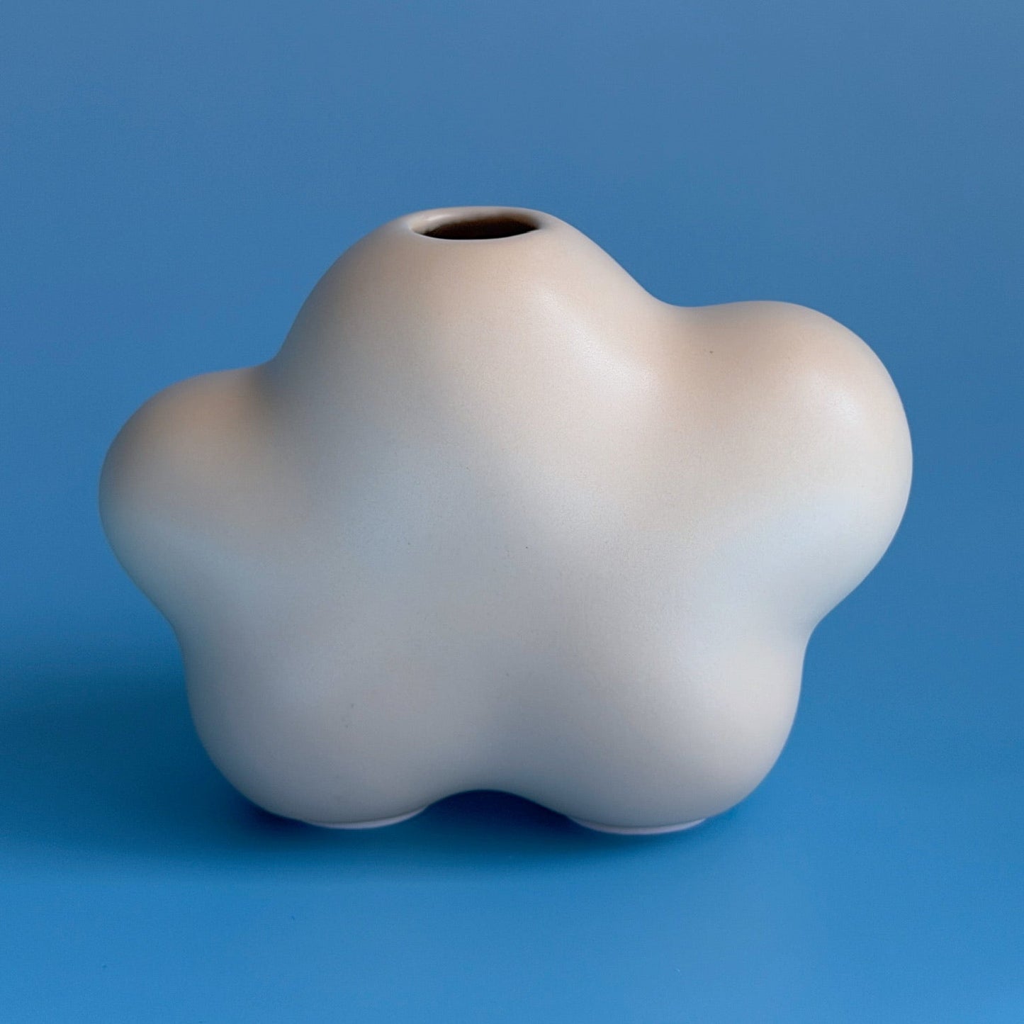 yellow white cloud bud vases on a blue blackground