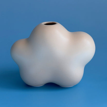 yellow white cloud bud vases on a blue blackground