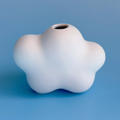 White cloud bud vase on a blue background