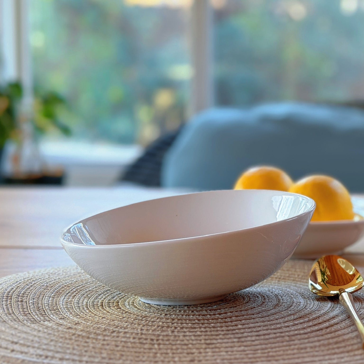 white asymmetrical bowl on a table with a blurred background