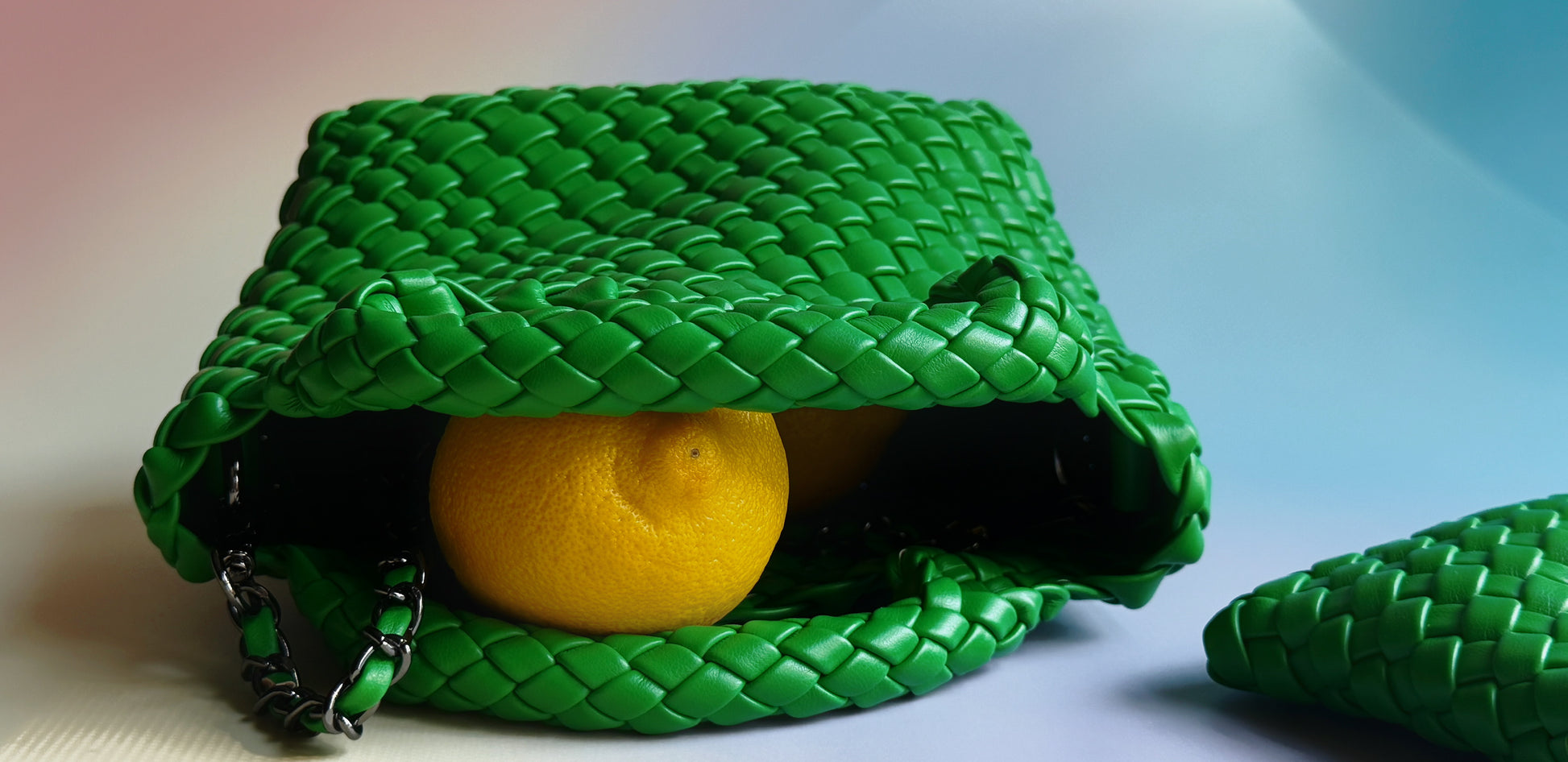 Green woven bag with a lemon inside on a light background