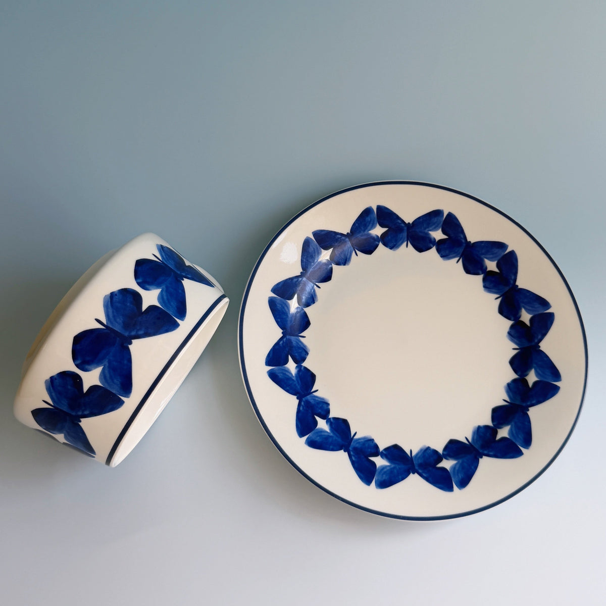 Adonis Blue Butterfly cup and saucer with blue butterfly border on white, viewed from above.