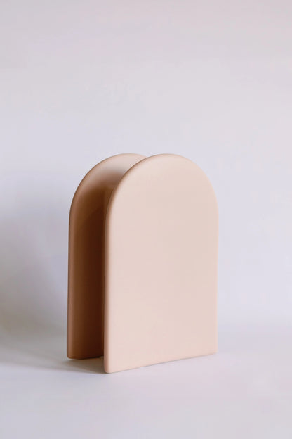 Arch Deco ceramic vase shown at an angle, blush front panel layered over a deeper tan arch back
