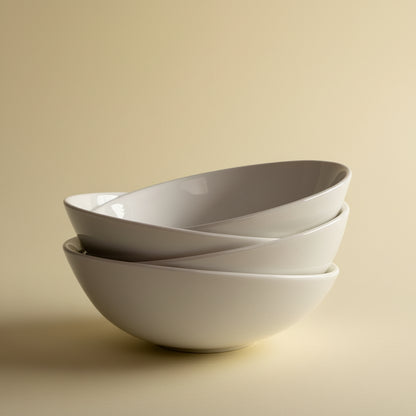 Asymmetrical porcelain dessert bowls with sculpted off-center rim in glossy white, set of 4