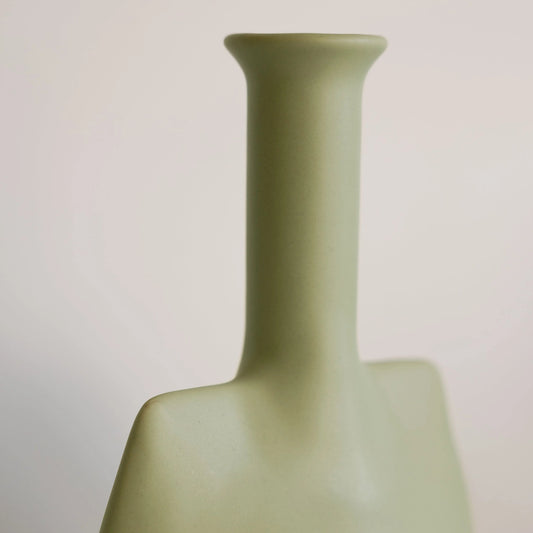 Sage green ceramic trowel bud vase close-up showing matte angular shoulder and slim flared neck