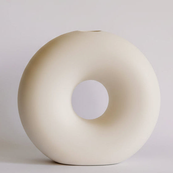 Donut Ceramic Bud Vase, cream matte ring-shaped vase with open center, shown full against a neutral backdrop.