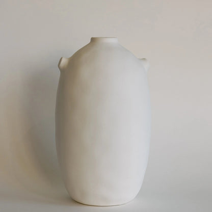Tall cream-white Kiln ceramic vase with smooth matte body and tiny shoulder nubs, front view