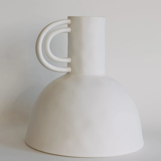 White ceramic carafe vase with rounded dome body and double-arch looped handle on the side