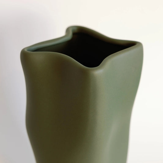 Olive green ripple vase close-up on the curved scalloped rim and open mouth