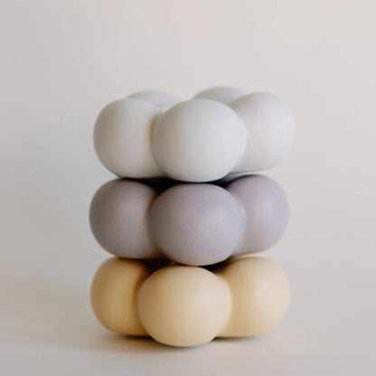Stacked bubble ceramic taper candle holder in white, lilac and pale yellow, three pastel cloud-shaped tiers