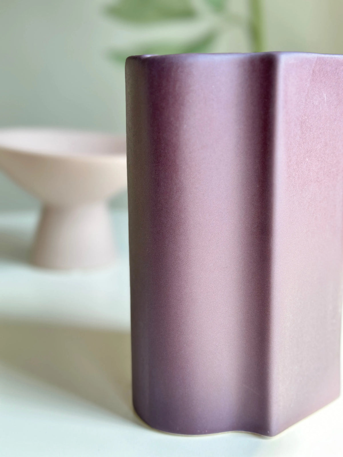 Plum Duo mauve vase close-up showing the curved faceted ridges and satin matte finish in soft light