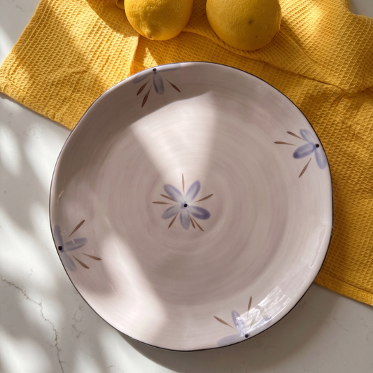Decorative ceramic bowl with floral patterns on a yellow cloth with lemons
