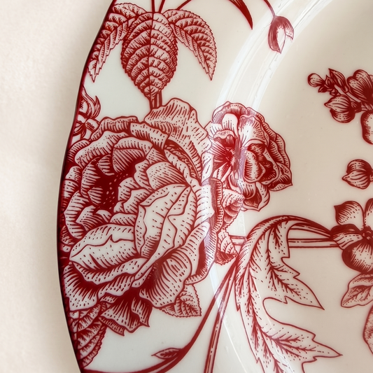 red and white floral salad plate on a bright cream background