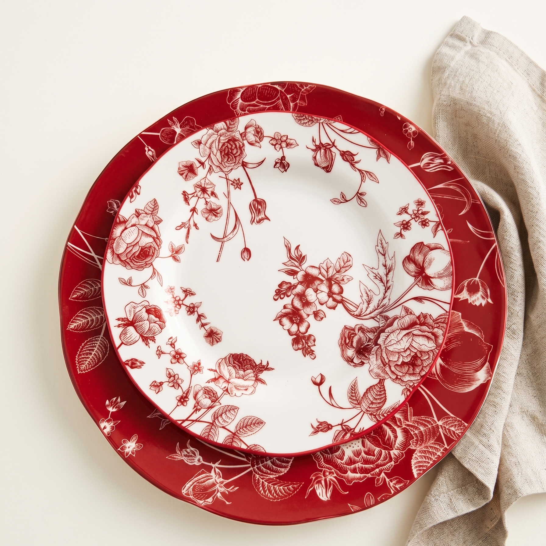 red and white floral plates on a bright cream background