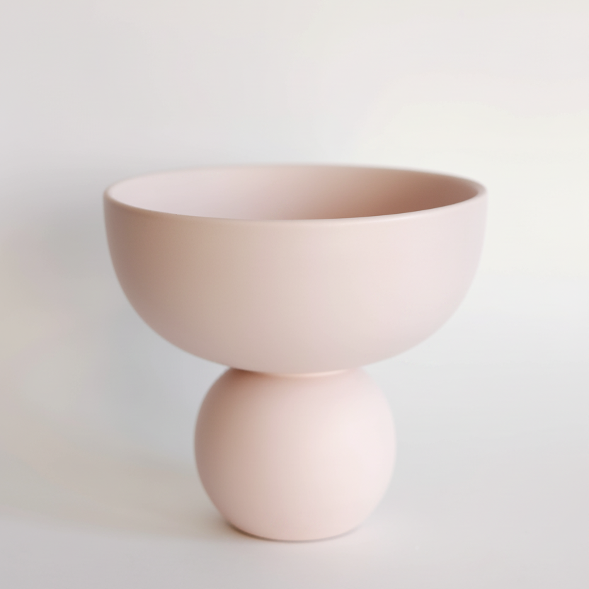 Sophie Ceramic Vase in blush pink, pedestal compote bowl on a round ball base against a neutral backdrop.