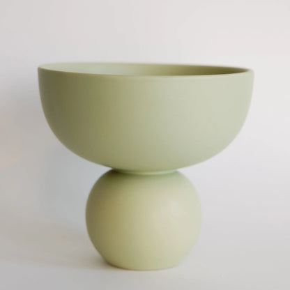 Sophie ceramic vase in sage green, matte bowl-on-sphere silhouette against a pale backdrop