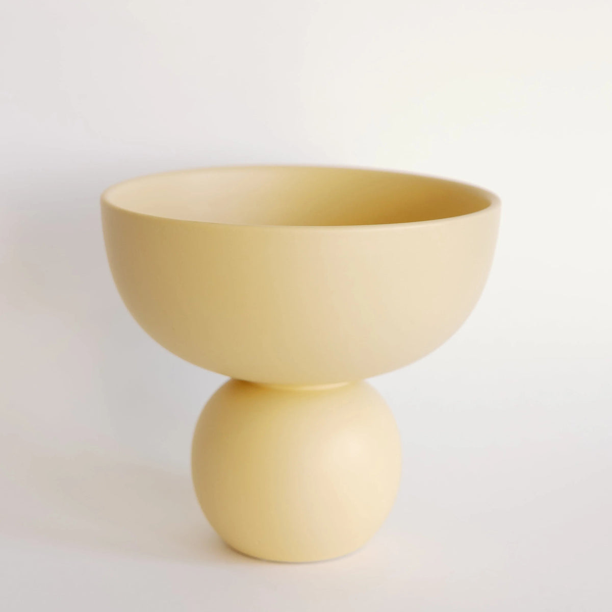 Sophie ceramic vase in pale butter yellow, rounded bowl atop a ball base with smooth matte glaze