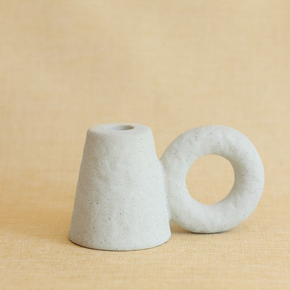 one white ceramic candle holder on a beige background